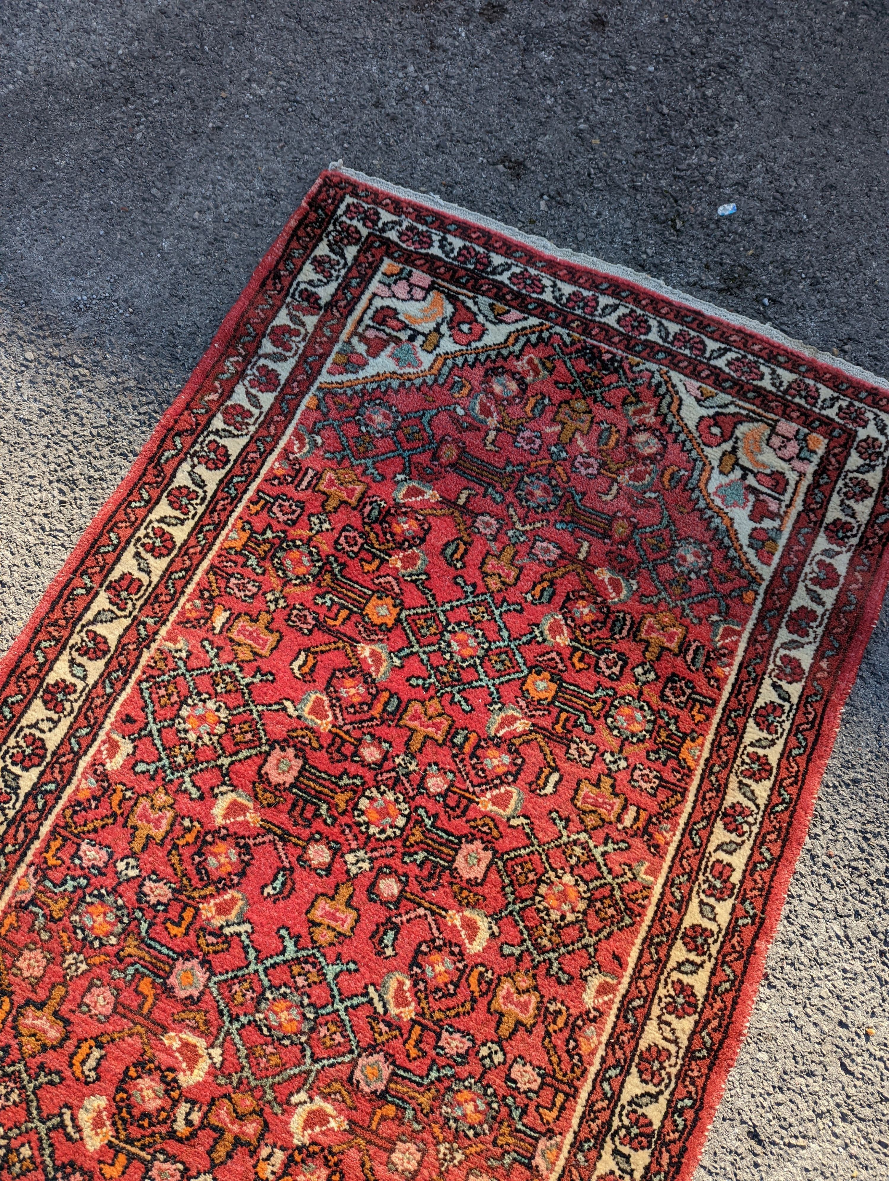 A North West Persian red ground runner, 290 x 82cm